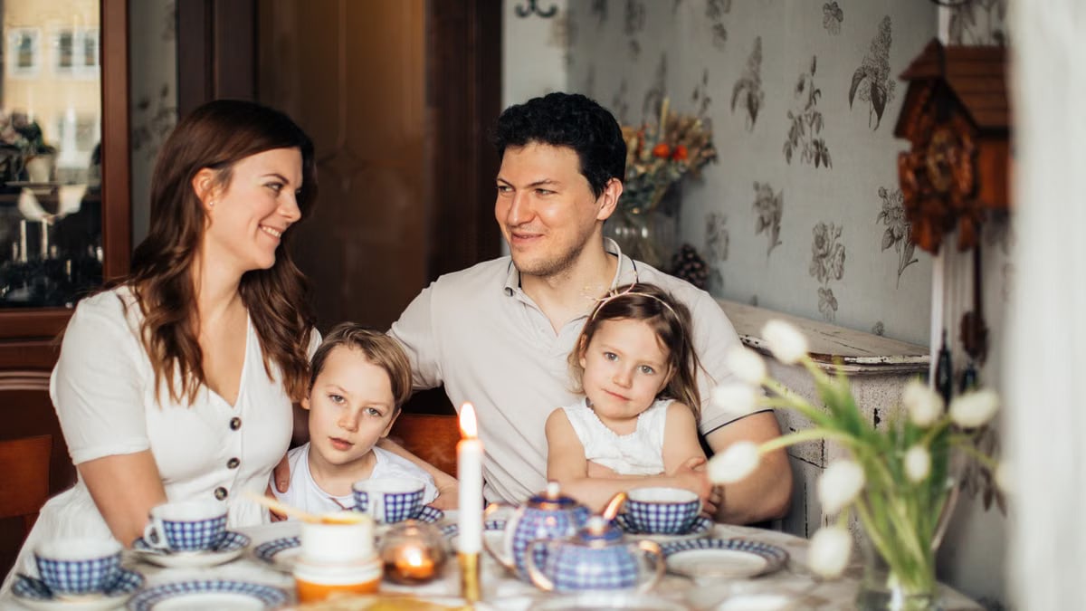 A warm family gathering celebrating a traditional Russian holiday indoors with festive food and decor.